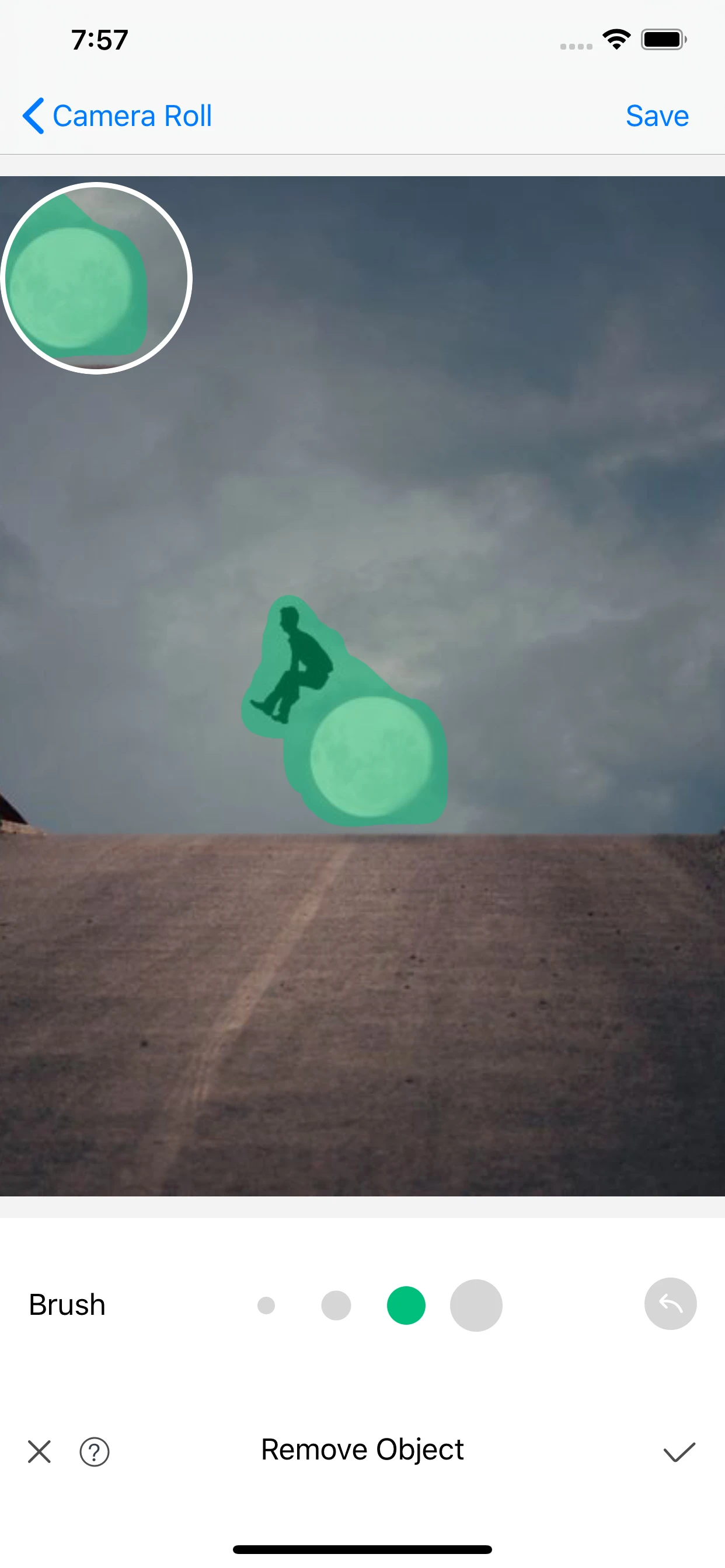 Actual current App Store screenshot showing the green removal brush mask and editing controls